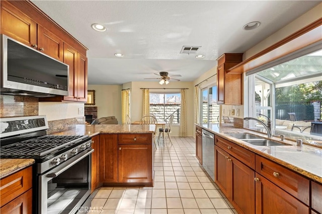 28610 Cloverleaf Pl, Castaic, CA 91384 - kitchen featuring stainless steel appliances, a peninsula, light tile patterned floors, tasteful backsplash, and ceiling fan