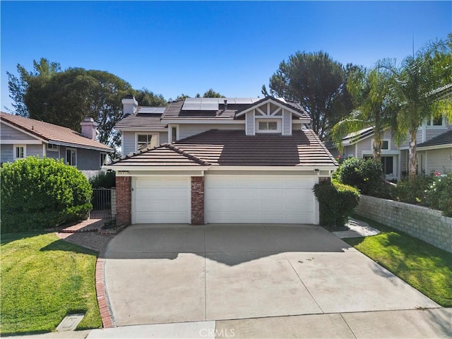 28610 Cloverleaf Pl, Castaic, CA 91384 - traditional-style home featuring a tile roof, concrete driveway, roof mounted solar panels, brick siding, and an attached garage