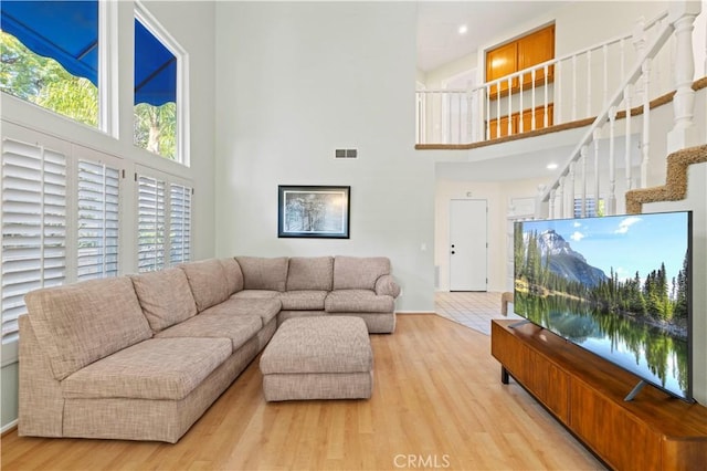 28610 Cloverleaf Pl, Castaic, CA 91384 - living area featuring a towering ceiling, wood finished floors, and stairway