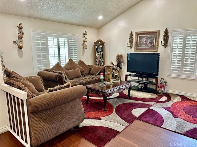 3210 S Center St, Santa Ana, CA 92704 - living room featuring a textured ceiling, lofted ceiling, and wood finished floors
