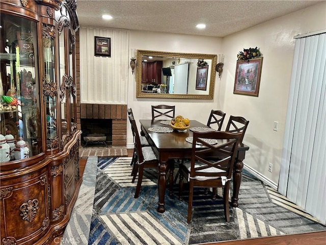 3210 S Center St, Santa Ana, CA 92704 - dining room with a textured ceiling, a fireplace, and recessed lighting