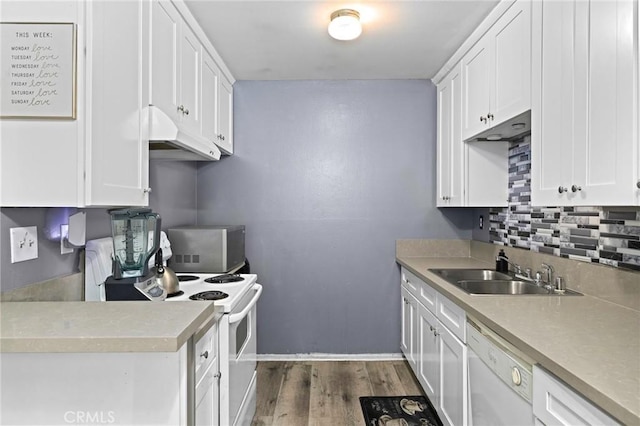5535 Ackerfield Ave Unit 47, Long Beach, CA 90805 - kitchen featuring white appliances, under cabinet range hood, tasteful backsplash, dark wood-style flooring, and white cabinetry