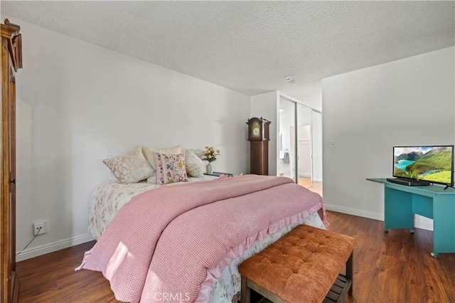25735 Hogan Dr Unit E11, Valencia, CA 91355 - bedroom featuring wood finished floors, a closet, and a textured ceiling