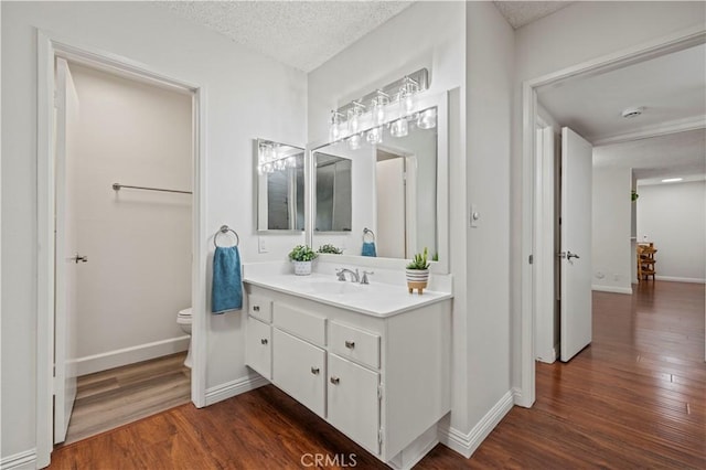 25735 Hogan Dr Unit E11, Valencia, CA 91355 - bathroom with wood finished floors, vanity, and a textured ceiling