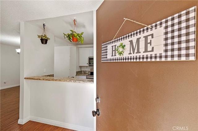 25735 Hogan Dr Unit E11, Valencia, CA 91355 - kitchen featuring stainless steel appliances, wood finished floors, and vaulted ceiling
