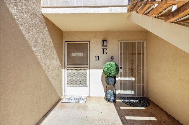 25735 Hogan Dr Unit E11, Valencia, CA 91355 - doorway to property featuring stucco siding