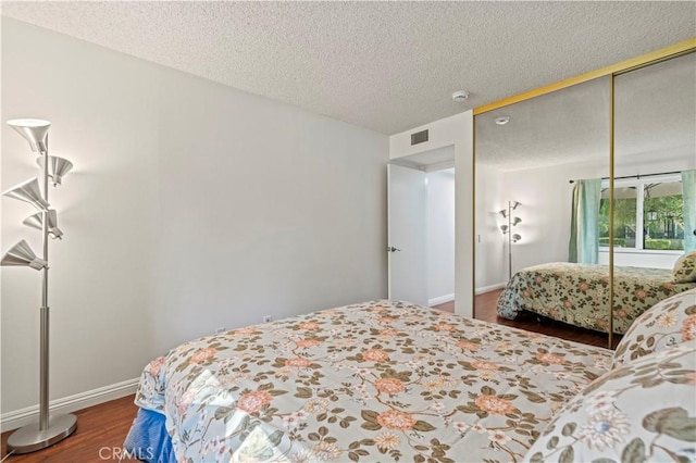 25735 Hogan Dr Unit E11, Valencia, CA 91355 - bedroom featuring wood finished floors, a closet, and a textured ceiling
