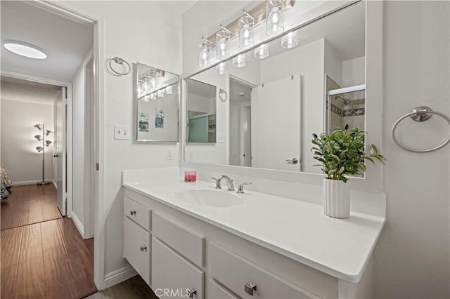25735 Hogan Dr Unit E11, Valencia, CA 91355 - bathroom featuring vanity, tiled shower, and wood finished floors