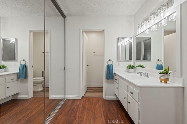 25735 Hogan Dr Unit E11, Valencia, CA 91355 - full bath featuring a textured ceiling, vanity, and wood finished floors