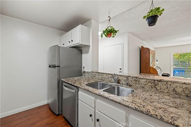 25735 Hogan Dr Unit E11, Valencia, CA 91355 - kitchen with dishwasher, dark wood-type flooring, white cabinets, light stone countertops, and a textured ceiling