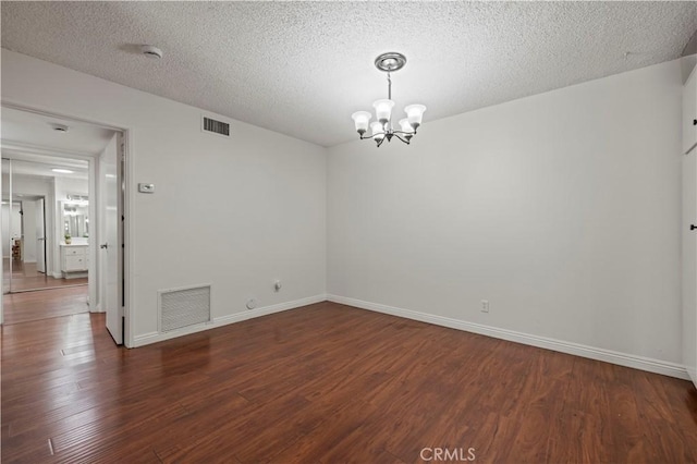 25735 Hogan Dr Unit E11, Valencia, CA 91355 - spare room with a chandelier, wood finished floors, a textured ceiling, and a smoke detector