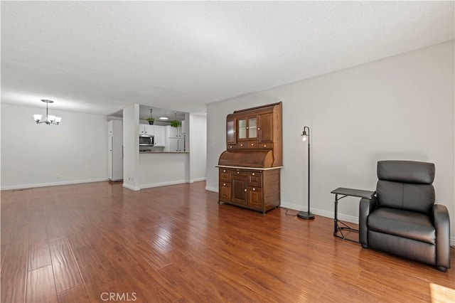 25735 Hogan Dr Unit E11, Valencia, CA 91355 - living area featuring a chandelier, wood finished floors, and a textured ceiling