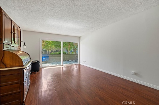25735 Hogan Dr Unit E11, Valencia, CA 91355 - living room featuring a textured ceiling and dark wood-style flooring