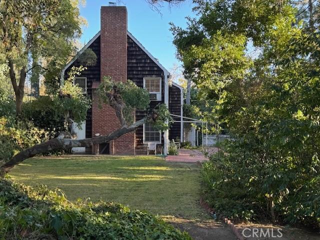 736 Burleigh Dr, Pasadena, CA 91105 - back of property featuring a chimney and a lawn
