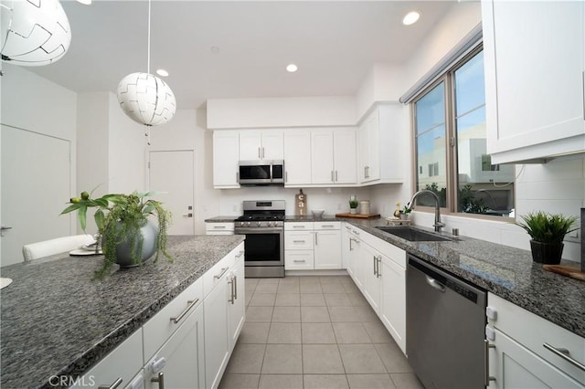 185 Magnet, Irvine, CA 92618 - kitchen featuring stainless steel appliances, white cabinetry, light tile patterned floors, and recessed lighting