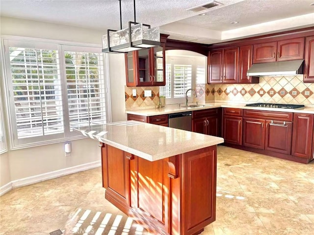 72 Coral Unit 38, Irvine, CA 92614 - kitchen featuring under cabinet range hood, stainless steel appliances, a textured ceiling, decorative backsplash, and glass insert cabinets