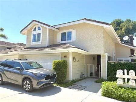 72 Coral Unit 38, Irvine, CA 92614 - view of front facade featuring a garage and driveway