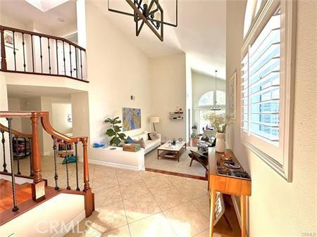 72 Coral Unit 38, Irvine, CA 92614 - entrance foyer with tile patterned flooring, high vaulted ceiling, and stairs