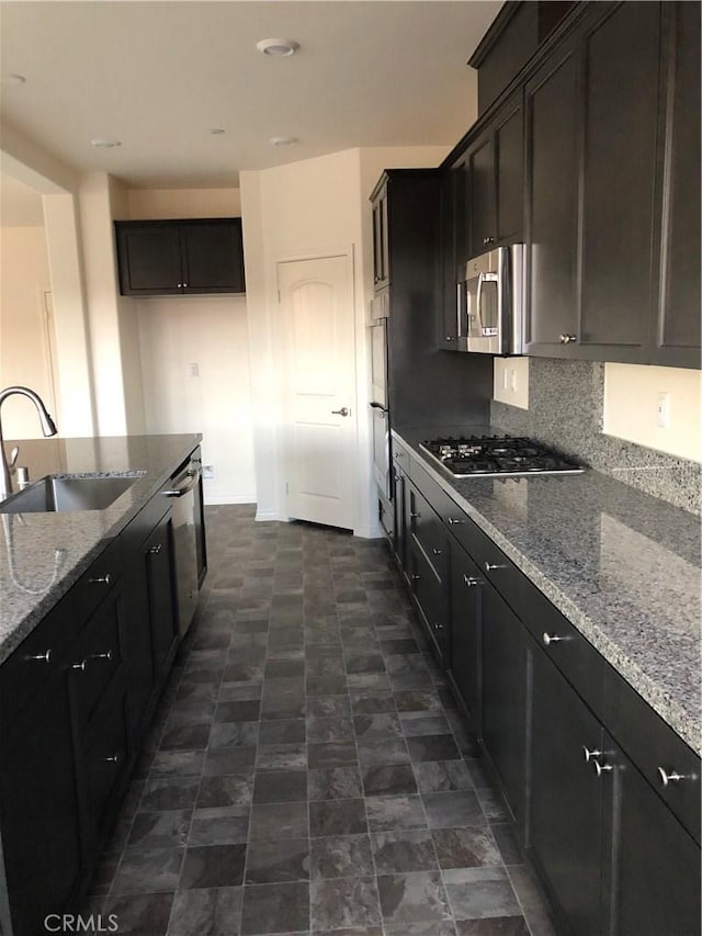 1031 Coriander St, Calimesa, CA 92320 - kitchen with appliances with stainless steel finishes, light stone countertops, and backsplash