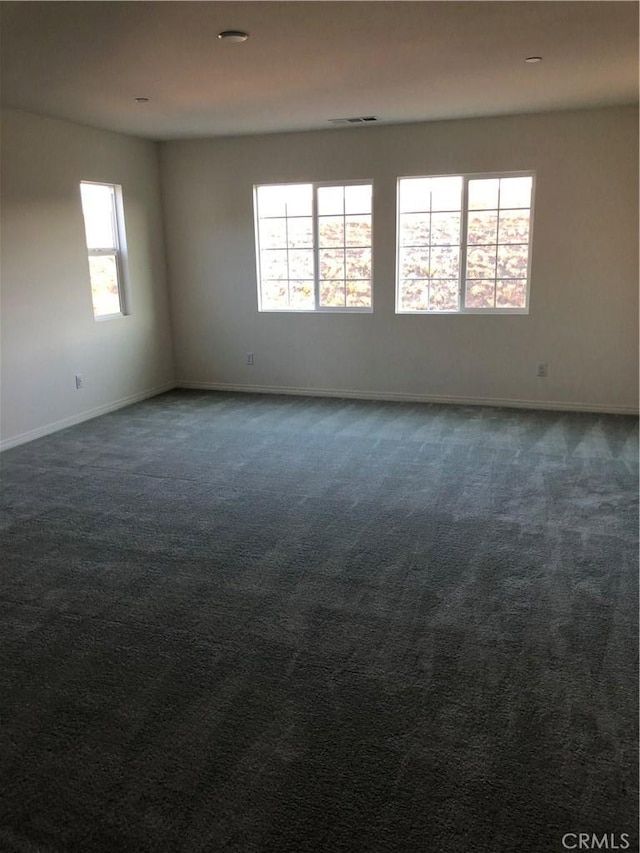 1031 Coriander St, Calimesa, CA 92320 - unfurnished room featuring healthy amount of natural light and dark carpet