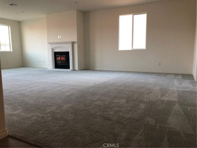 1031 Coriander St, Calimesa, CA 92320 - unfurnished living room with carpet, plenty of natural light, and a glass covered fireplace