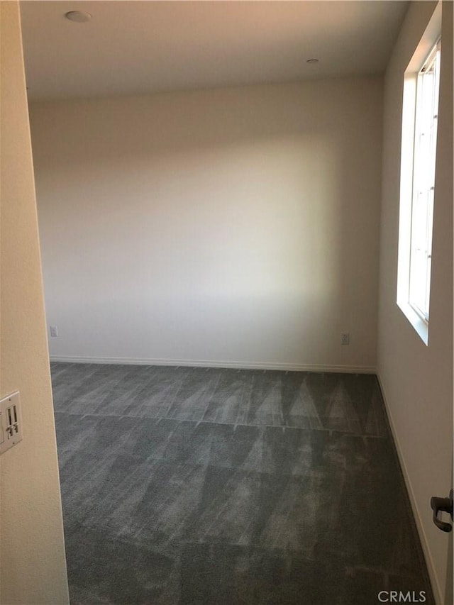 1031 Coriander St, Calimesa, CA 92320 - empty room featuring dark colored carpet and baseboards
