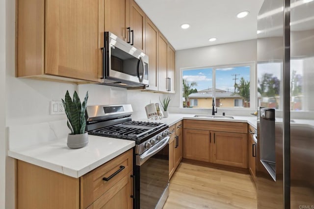 3821 Shiloh Rd, San Diego, CA 92105 - kitchen with stainless steel appliances, light wood-style flooring, light countertops, recessed lighting, and brown cabinets