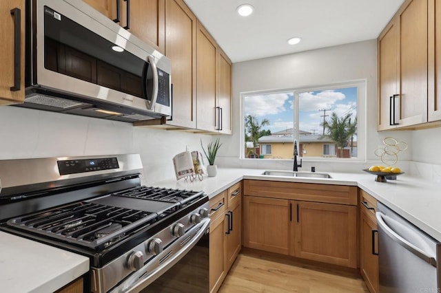 3821 Shiloh Rd, San Diego, CA 92105 - kitchen featuring stainless steel appliances, recessed lighting, light countertops, light wood-type flooring, and brown cabinetry