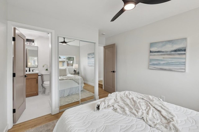3821 Shiloh Rd, San Diego, CA 92105 - bedroom with light wood-type flooring, a closet, ensuite bath, and ceiling fan