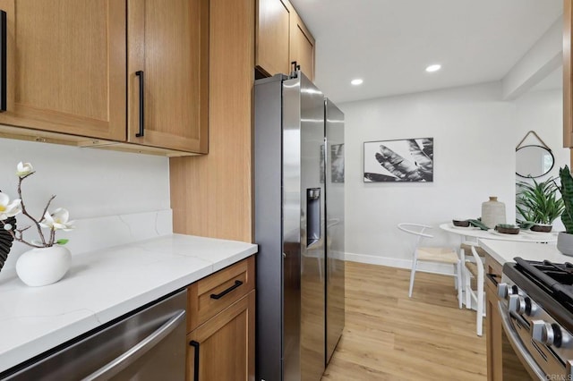 3821 Shiloh Rd, San Diego, CA 92105 - kitchen featuring stainless steel appliances, light wood-type flooring, brown cabinets, light stone counters, and recessed lighting