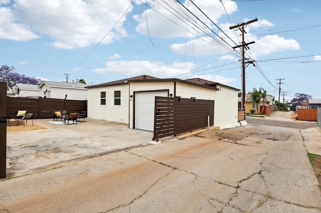 3821 Shiloh Rd, San Diego, CA 92105 - view of property exterior featuring stucco siding, an outbuilding, and a garage