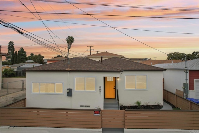 3821 Shiloh Rd, San Diego, CA 92105 - view of front facade with a fenced front yard, stucco siding, and roof with shingles