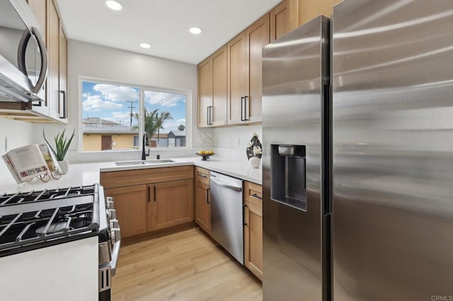 3821 Shiloh Rd, San Diego, CA 92105 - kitchen with stainless steel appliances, recessed lighting, light wood-style floors, light countertops, and brown cabinetry