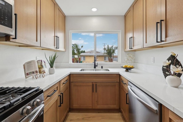 3821 Shiloh Rd, San Diego, CA 92105 - kitchen featuring stainless steel appliances, light countertops, light wood-type flooring, recessed lighting, and brown cabinets