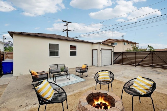 3821 Shiloh Rd, San Diego, CA 92105 - fenced backyard with an outdoor living space with a fire pit, a patio, concrete driveway, and an attached garage