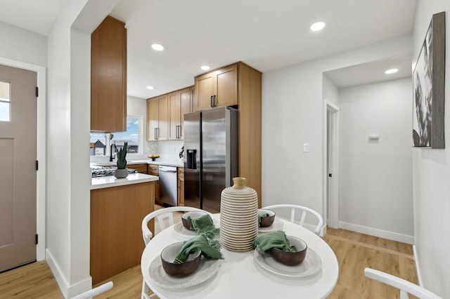 3821 Shiloh Rd, San Diego, CA 92105 - kitchen featuring stainless steel appliances, light countertops, light wood-style flooring, recessed lighting, and brown cabinetry