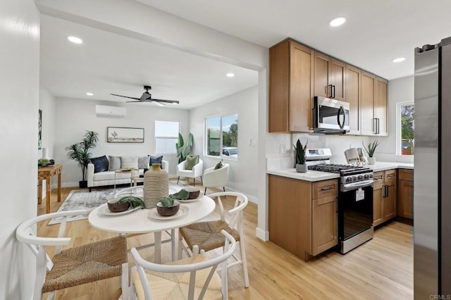 3821 Shiloh Rd, San Diego, CA 92105 - kitchen featuring stainless steel appliances, light wood-style flooring, recessed lighting, light countertops, and a wall unit AC