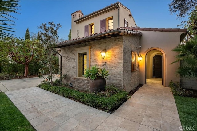 3 Coral Cay, Newport Coast, CA 92657 - view of front of home featuring a chimney, stucco siding, and a tile roof