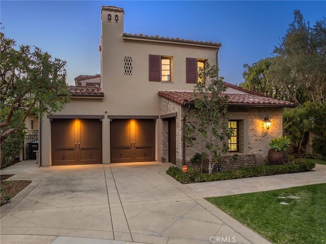 3 Coral Cay, Newport Coast, CA 92657 - mediterranean / spanish-style house with a tiled roof, an attached garage, concrete driveway, and stucco siding