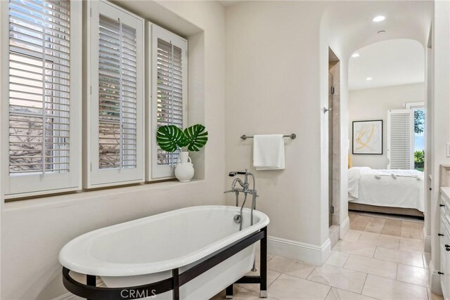 3 Coral Cay, Newport Coast, CA 92657 - full bath with healthy amount of natural light, a soaking tub, and tile patterned floors