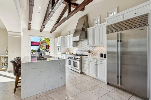3 Coral Cay, Newport Coast, CA 92657 - kitchen featuring high quality appliances, wall chimney exhaust hood, backsplash, and white cabinets