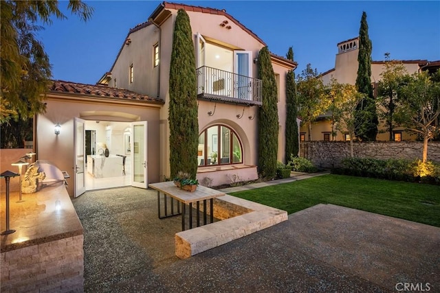 3 Coral Cay, Newport Coast, CA 92657 - back of house with a balcony, a tile roof, a patio, and a lawn