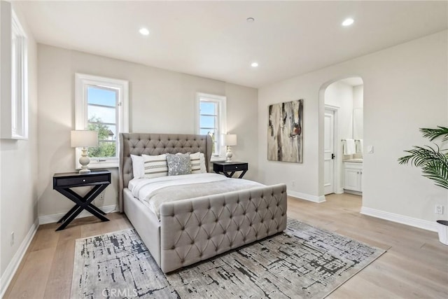 3 Coral Cay, Newport Coast, CA 92657 - bedroom with arched walkways, light wood-type flooring, multiple windows, recessed lighting, and ensuite bathroom