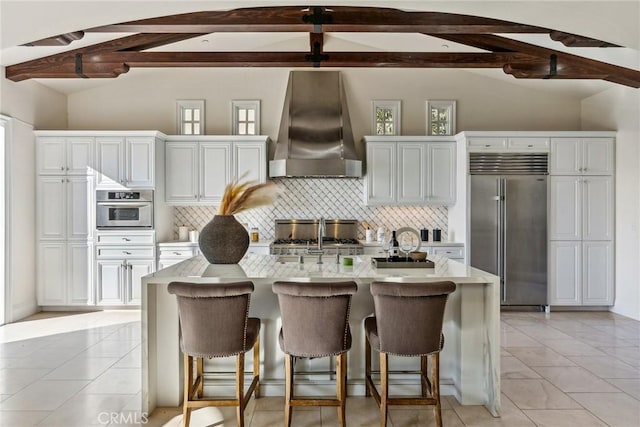 3 Coral Cay, Newport Coast, CA 92657 - kitchen with appliances with stainless steel finishes, wall chimney exhaust hood, light countertops, and backsplash