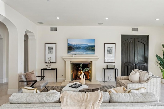 3 Coral Cay, Newport Coast, CA 92657 - living area featuring arched walkways, a warm lit fireplace, and recessed lighting