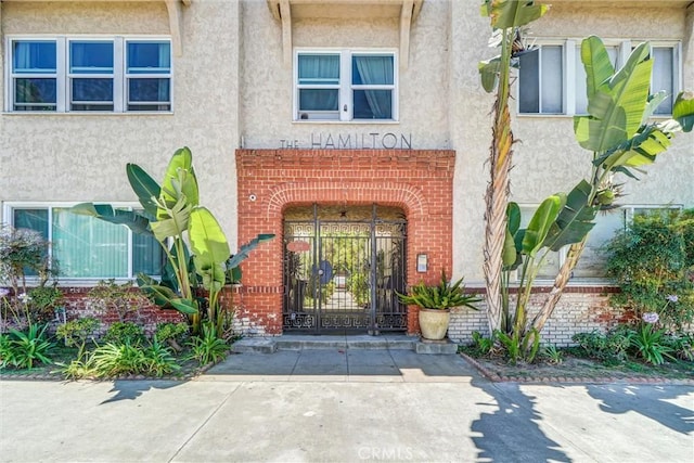 1616 E Ocean Blvd Unit 6, Long Beach, CA 90802 - doorway to property with stucco siding, brick siding, and a gate