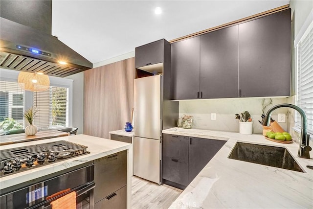 1616 E Ocean Blvd Unit 6, Long Beach, CA 90802 - kitchen with range hood, freestanding refrigerator, wall oven, black gas stovetop, and light stone counters