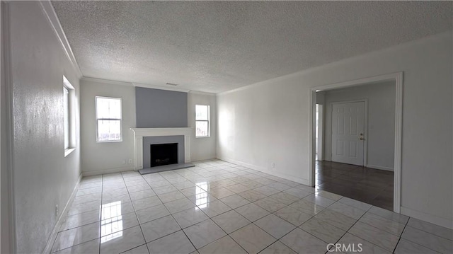 9614 Graham Ave, Los Angeles, CA 90002 - unfurnished living room with ornamental molding, a textured ceiling, a fireplace with raised hearth, and light tile patterned flooring