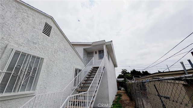 9614 Graham Ave, Los Angeles, CA 90002 - view of home's exterior featuring stucco siding and stairway