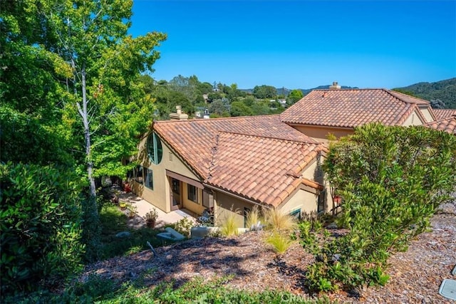6271 Twinberry Cir Unit 6, Avila Beach, CA 93424 - back of house featuring stucco siding, a tile roof, and a chimney